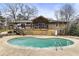 Backyard showcasing a large swimming pool and a charming home with a spacious deck at 330 Chaffin Ridge Ct, Roswell, GA 30075