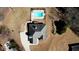 Aerial view of house showing driveway, yard, and in-ground pool, surrounded by lawn and trees at 75 Horseshoe Dr, Covington, GA 30014