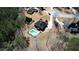Aerial view of home and surrounding neighborhood, showing in-ground pool and surrounding trees at 75 Horseshoe Dr, Covington, GA 30014