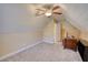 Spacious attic room with neutral carpet, ceiling fan, and unique architecture at 75 Horseshoe Dr, Covington, GA 30014