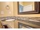 Bathroom vanity featuring a mosaic tile backsplash and a reflective countertop at 75 Horseshoe Dr, Covington, GA 30014