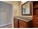 Bathroom featuring tile accents, a wooden vanity, a mirror and shelving unit at 75 Horseshoe Dr, Covington, GA 30014