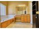 Bathroom with a large tub, vanity, and mirror, and a decorative cabinet at 75 Horseshoe Dr, Covington, GA 30014