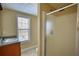 Well-lit bathroom with a shower, vanity with granite countertop, and large window at 75 Horseshoe Dr, Covington, GA 30014