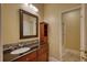 Elegant bathroom featuring tile accents, a wooden vanity, a mirror and shower at 75 Horseshoe Dr, Covington, GA 30014