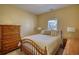 Bedroom with a comfy bed, a window view, and a wooden dresser at 75 Horseshoe Dr, Covington, GA 30014