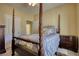 Bedroom with a four-poster bed and a view of the hallway and bathroom at 75 Horseshoe Dr, Covington, GA 30014