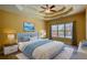 Well-decorated primary bedroom with neutral wall color, tray ceiling, large window, and comfortable king-size bed at 75 Horseshoe Dr, Covington, GA 30014