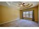 Spacious bedroom features tray ceiling, large window with natural light, neutral carpeting, and yellow walls at 75 Horseshoe Dr, Covington, GA 30014