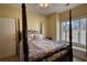 Bedroom with a four-poster bed and a window seat overlooking the yard at 75 Horseshoe Dr, Covington, GA 30014