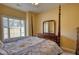 Bedroom featuring a four-poster bed, dresser, and a sunny window at 75 Horseshoe Dr, Covington, GA 30014
