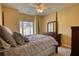 Bedroom featuring a four-poster bed, dresser, and view of the backyard at 75 Horseshoe Dr, Covington, GA 30014
