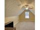 Bright bonus room with neutral carpet, angled ceilings, ceiling fan, and a window at 75 Horseshoe Dr, Covington, GA 30014