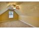 Finished bonus room with neutral carpet, angled ceilings, ceiling fan, and a window at 75 Horseshoe Dr, Covington, GA 30014