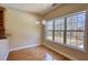 Bright dining area featuring hardwood floors and large windows showcasing a beautiful outdoor view at 75 Horseshoe Dr, Covington, GA 30014