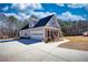 A well-manicured home with a long drive leading to an attached garage on a sunny day at 75 Horseshoe Dr, Covington, GA 30014