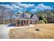 Well-maintained brick home with gray siding, landscaped front yard, and welcoming entrance at 75 Horseshoe Dr, Covington, GA 30014