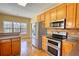 Kitchen with wood cabinets, stainless steel appliances, and an attached dining area at 75 Horseshoe Dr, Covington, GA 30014