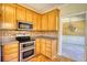 Kitchen features wood cabinets, stainless steel appliances, and tile backsplash at 75 Horseshoe Dr, Covington, GA 30014
