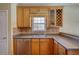 Cozy kitchen with wood cabinets, stainless steel appliances, tile backsplash, and breakfast bar at 75 Horseshoe Dr, Covington, GA 30014