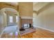 Charming brick fireplace in a cozy living room with hardwood floors and decorative archways at 75 Horseshoe Dr, Covington, GA 30014