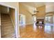 Open-concept living room with hardwood floors, a cozy fireplace, and stairs to the second level at 75 Horseshoe Dr, Covington, GA 30014