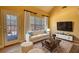 Cozy living room with a comfortable sofa and view of the backyard pool at 75 Horseshoe Dr, Covington, GA 30014