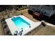 Aerial view of a beautiful in-ground pool, fenced in for safety, perfect for summertime relaxation at 75 Horseshoe Dr, Covington, GA 30014