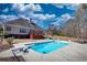 A fenced-in in-ground pool is equipped with a diving board and features a concrete patio and a small deck at 75 Horseshoe Dr, Covington, GA 30014