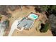 Aerial view of fenced in in-ground pool and the surrounding backyard and home at 75 Horseshoe Dr, Covington, GA 30014