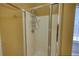 Bathroom featuring glass enclosed shower with storage rack and a glass block window at 75 Horseshoe Dr, Covington, GA 30014