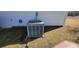 The green air conditioning unit sits just outside the home on a bed of grass at 903 Tucker Ln, Loganville, GA 30052