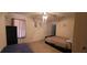 Spacious bedroom featuring two beds, ceiling fan, and neutral carpet at 903 Tucker Ln, Loganville, GA 30052