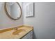 Half bath featuring a marble countertop and a round decorative mirror at 505 S Malton S Ct, Stone Mountain, GA 30083