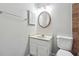 Bathroom with sink vanity, a wall mirror, and neutral decor at 505 S Malton S Ct, Stone Mountain, GA 30083