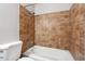 Bathroom with ceramic tile enclosure and a white tub at 505 S Malton S Ct, Stone Mountain, GA 30083