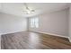 Spacious bedroom features wood-look flooring, neutral paint, and a ceiling fan at 505 S Malton S Ct, Stone Mountain, GA 30083