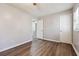 Spacious bedroom features wood-look flooring, neutral paint, baseboards, and a ceiling fan at 505 S Malton S Ct, Stone Mountain, GA 30083