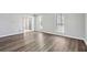 Bright living room featuring neutral tones, hardwood flooring, and large windows for ample natural light at 505 S Malton S Ct, Stone Mountain, GA 30083