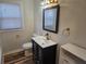 Bathroom vanity with modern faucet, stylish mirror, and a toilet at 938 Rebel Forest Se Dr, Atlanta, GA 30315