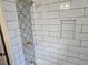Bathroom boasts white subway tile with decorative accent stripe and convenient shower niche at 938 Rebel Forest Se Dr, Atlanta, GA 30315
