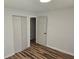 Bedroom features wood floors, closet, and adjacent door to the hallway at 938 Rebel Forest Se Dr, Atlanta, GA 30315