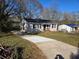 Single-story home with a freshly paved driveway and a well-maintained lawn at 938 Rebel Forest Se Dr, Atlanta, GA 30315