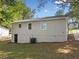 The rear view of the home shows the siding, windows, and access to the backyard at 938 Rebel Forest Se Dr, Atlanta, GA 30315