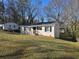 Charming single-story home with white exterior, updated windows, and manicured lawn at 938 Rebel Forest Se Dr, Atlanta, GA 30315