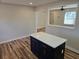 Kitchen with an island featuring a quartz countertop, stylish cabinets, and new hardwood floors at 938 Rebel Forest Se Dr, Atlanta, GA 30315