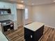Open kitchen featuring an island with quartz countertop, new cabinets, and stainless steel appliances at 938 Rebel Forest Se Dr, Atlanta, GA 30315