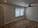 Bright living room with wood-look floors, a window, and a ceiling fan at 938 Rebel Forest Se Dr, Atlanta, GA 30315