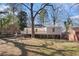 The house is surrounded by a beautiful lawn and mature trees at 1922 Willa Dr, Decatur, GA 30032