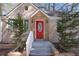 The front door features a red door with a brick and stone surround at 1922 Willa Dr, Decatur, GA 30032